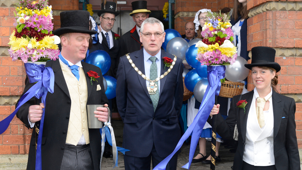 Town Hall steps, Hocktide 2013, including Fiona Hobson (far right) and fellow Tithingman holding a Tutti-pole
